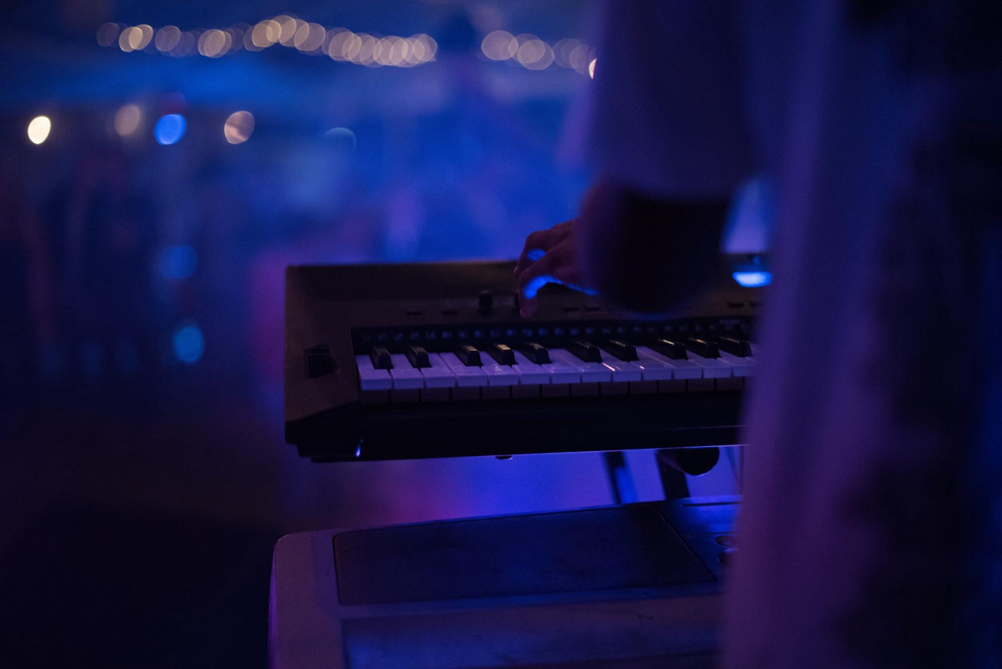 Keyboard on stage under blue lights